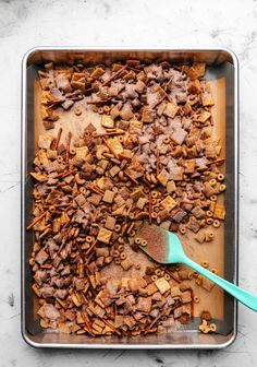 a baking pan filled with homemade dog treats and a spatula on the side,