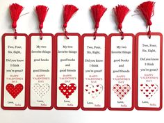 four valentine's day bookmarks with red tassels hanging from the sides