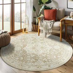 a living room filled with furniture and a large rug on the floor next to a window