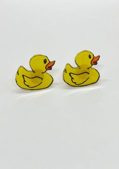 two yellow rubber ducks sitting next to each other