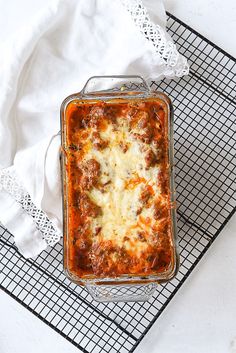 a casserole dish with meat and cheese in it on a wire cooling rack