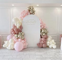 a balloon arch with balloons on the floor