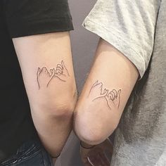 two people with matching tattoos on their arms