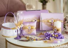 a table topped with purple and gold items