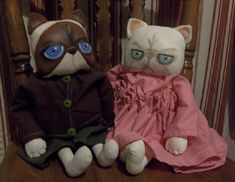 two stuffed animals sitting on top of a wooden chair