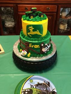 two cakes decorated with farm animals are on a table