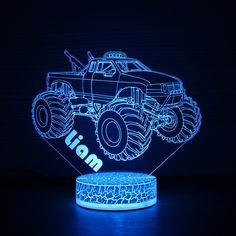 an illuminated monster truck is shown in the dark