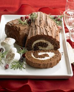 a chocolate cake with cream filling on a white plate