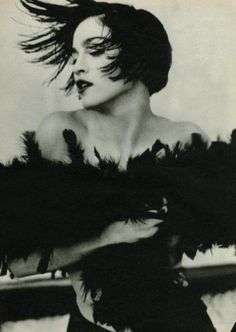 a black and white photo of a woman with her hair blowing in the wind,