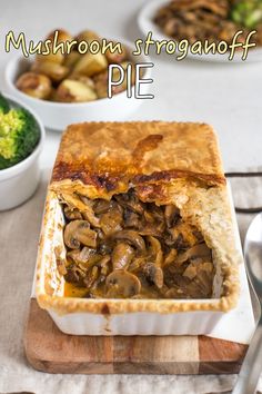 mushroom stroganooffe pie in a white casserole dish with broccoli on the side