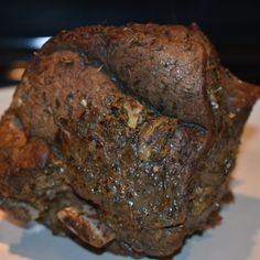 a piece of meat sitting on top of a white plate