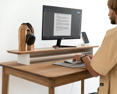 a man sitting at a desk using a computer