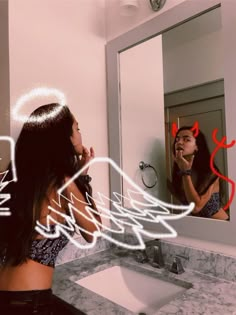 a woman brushing her teeth in front of a mirror with the word love written on it