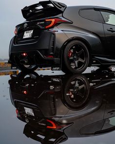 the rear end of a black sports car