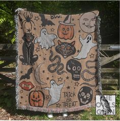 a halloween themed blanket hanging on a fence