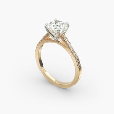 a yellow gold engagement ring with an oval cut diamond and side stones