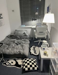 a bedroom with a bed, desk and chair in the corner next to a window