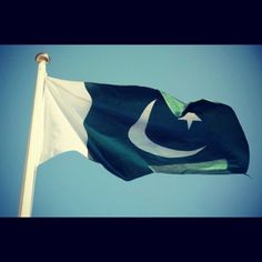 the pakistan flag is flying high in the sky