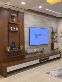 a large flat screen tv mounted to the side of a wooden entertainment center in a living room