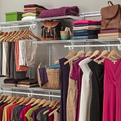 a closet filled with lots of different colored clothes and handbags on shelves next to each other