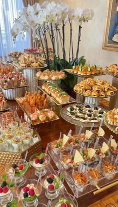 a table filled with lots of desserts and pastries