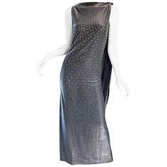 Rare Musuem Worthy 60s GEOFFREY BEENE Couture gunmetal + silver metallic silk lurex caped evening dress! Luxurioussoft (not scratchy at all) silk lurex fabric. Features hundreds of hand-sewn silver metal studs and rhinestones on the front. Attached cape makes for an chic dramatic entrance, and attaches at top left shoulder with three-hook-and-eye closures. Hidden metal zipper up the side. Looks amazing on, and is a true testimony to 1960s American couture! Obviously, there is a ton of attention Grey Evening Dresses, Cape Gown, Vintage Cape, Silk Chiffon Dress, Geoffrey Beene, Designer Evening Dresses, Sleeveless Gown, Hook And Eye, 1960s Fashion