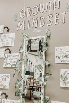 the growth mindset sign is displayed in front of a wall with signs on it