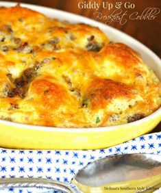 a casserole dish with meat and cheese in it on a blue and white cloth