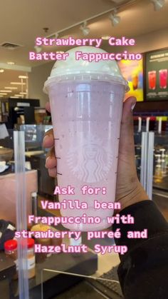 someone is holding up a starbucks cup with the words, strawberry cake batterer cappuccino