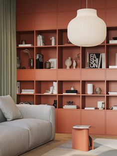 a living room filled with furniture and bookshelves next to a wall covered in shelves