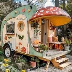 an old camper converted into a tiny house with mushrooms on the roof and windows