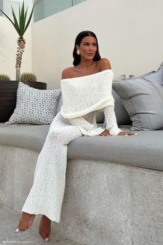 Wrapped up.MARISOL is a ribbed design boucle dress that is both flattering from up close and across the room. The natural stretch of the fabric creates a figure-sculpting silhouette, while also featuring a unique drape-styled, off-shoulder neckline combined with flared long sleeves. Style your maxi dress with the Colleen Buckle Heel to complete the look, perfect for occasions such as a bridal shower. Adding to its allure, the MARISOL Boucle Dress offers a sophisticated and modern aesthetic that