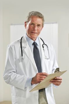 a man in a white coat and tie holding a clipboard with a stethoscope on it