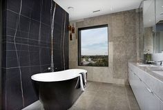 a bathroom with a large bathtub next to a window