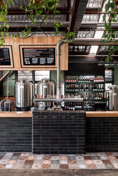 the interior of a small bar with lots of bottles on it and menus hanging from the ceiling