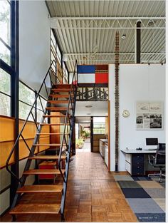 an open floor plan with stairs leading up to the upper level and office space below