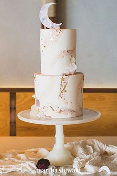 a three tiered wedding cake on a table