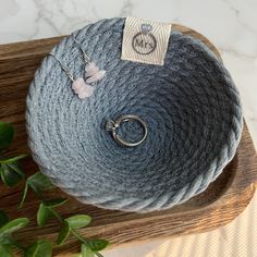 a skein of yarn on top of a wooden cutting board next to a plant