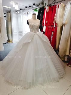 a white wedding dress on display in a store