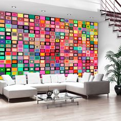 a living room filled with furniture and a colorful wall