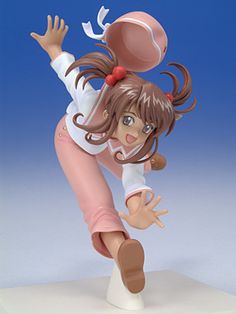 a figurine of a girl playing with a ball on top of a table