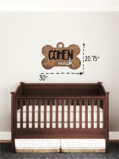 a wooden sign that says cofon musk on the side of a baby's crib