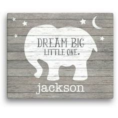 a wooden sign that says dream big little one with an elephant and stars on it