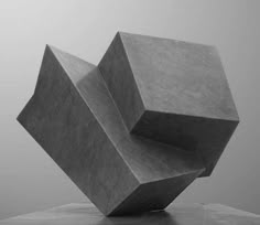 an abstract sculpture sitting on top of a wooden table