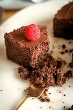 a piece of chocolate cake with a raspberry on top