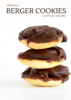 three chocolate covered doughnuts stacked on top of each other in front of a white background