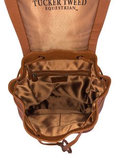 the inside of a tan leather bag with its zipper open and it's interior showing