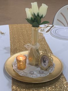 white roses in a vase on a gold plate