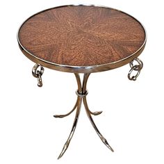 a round table with two metal legs and a wooden top on an isolated white background