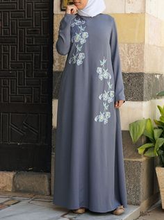 Elegant Floor-length Thobe With Floral Embroidery, Spring Abaya With Floral Embroidery, Spring Long Abaya With Floral Embroidery, Spring Abaya With Modesty Panel, Spring Floral Embroidered Long Abaya, Spring Floral Embroidered Abaya, Modest Embroidered Maxi Abaya, Embroidered Modest Maxi Abaya, Elegant Long Sleeve Thobe With Floral Embroidery